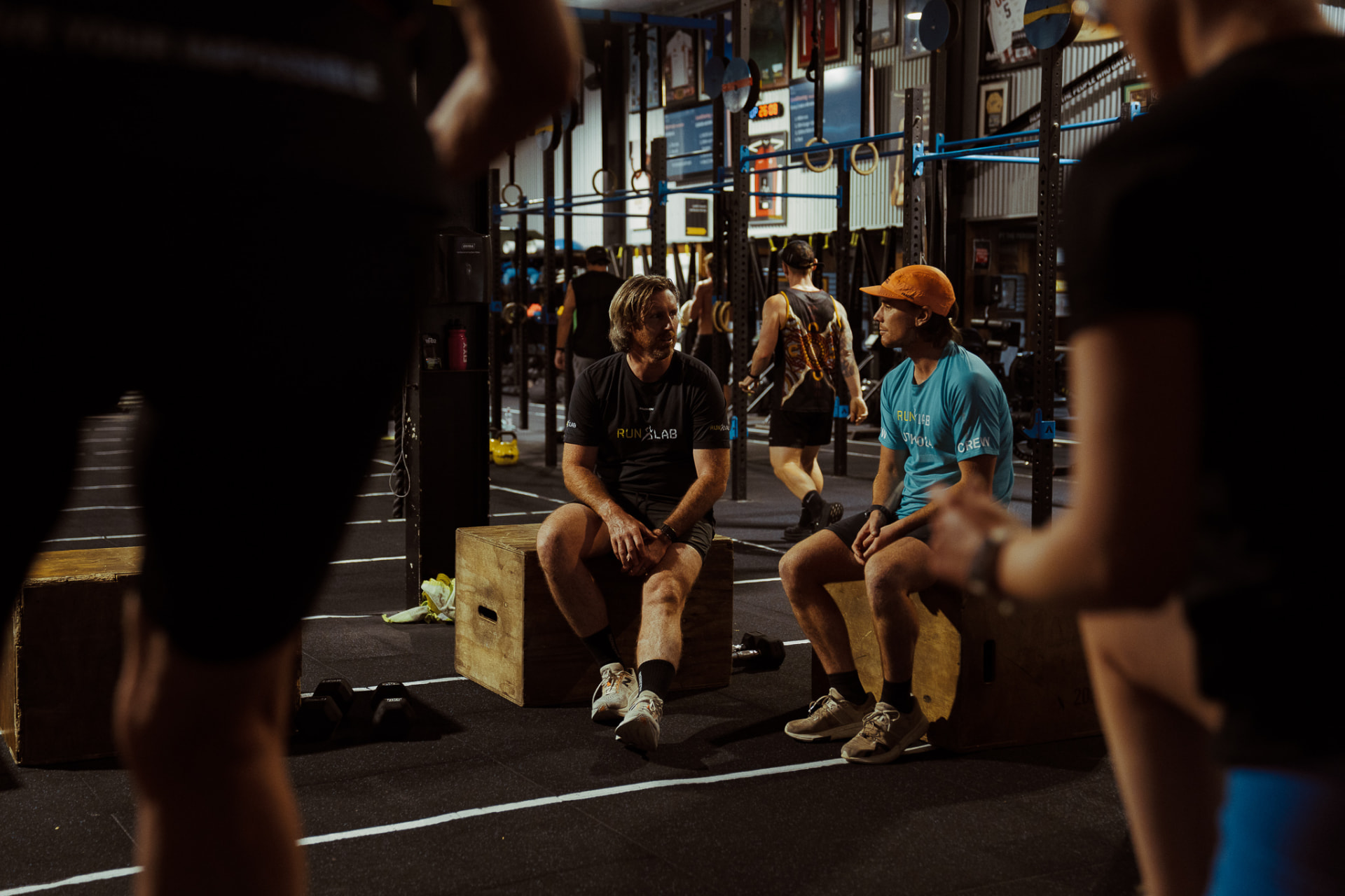 RunLab coaches talking between efforts in the gym