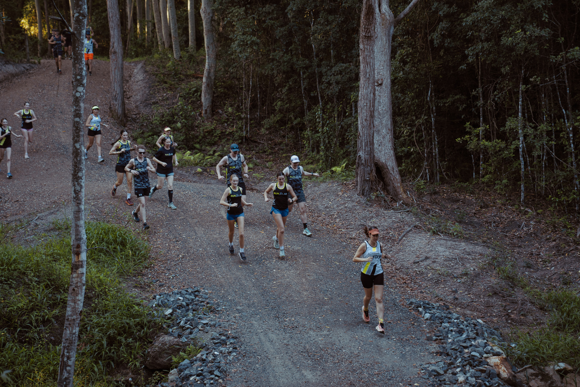 A RunLab group running together along the coast at dusk